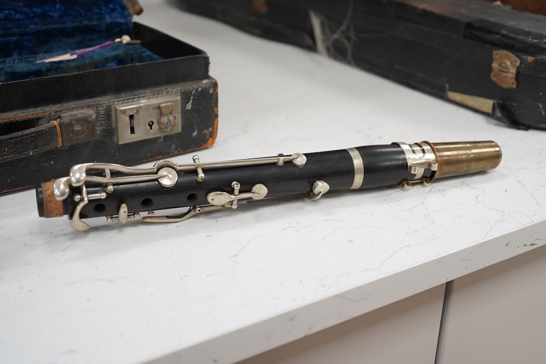 An early 20th century wooden Boosey and Hawkes clarinet in a fitted leather case